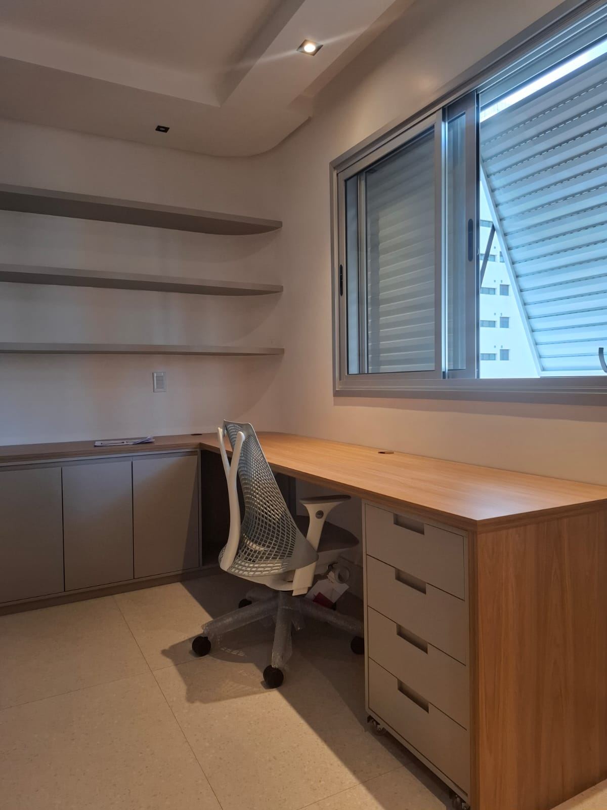 Home office com mesa sob medida e prateleiras
